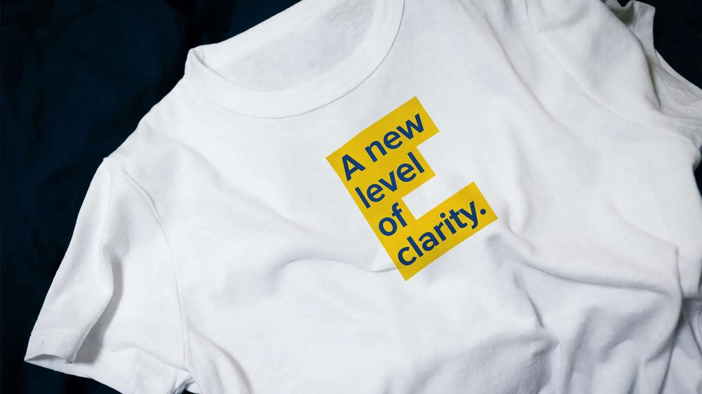 white t shirt with the text "a new level of clarity" on it.